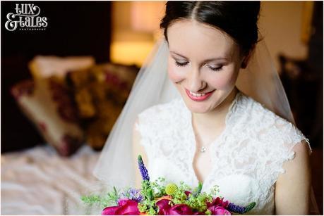 York wedding photography bride looks at brightly coloured bouquet