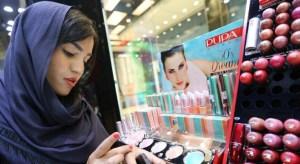 An Iranian woman checks make up at a cosmetics shop in northern Tehran on May 6, 2014. (photo credit: AFP/Atta Kenare) 