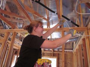 There I am, stringing wire in a Habitat for Humanity house.