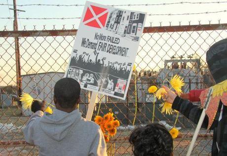 In December, students left flowers at the fence of a former chemical plant in South Baltimore where a trash incinerator is proposed. Photo by: Fern Shen