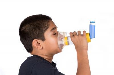 Thank god we have modern medicine! Child using asthma inhaler. Image courtesy of Arvind Balaraman / FreeDigitalPhotos.net