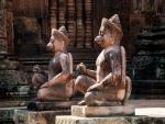 Guarded by two kneeling statues of human figures with animal heads