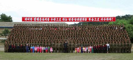 Kim Jong Un attends a commemorative photo-op with Hwa Islet Defense Detachment's service members, officers and their families (Photo: Rodong Sinmun).