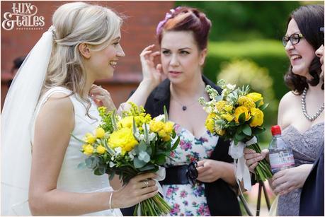 Candid wedding photograph of bride talking to guests