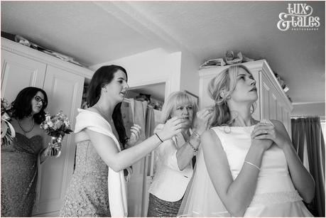 Documentary wedding photography of mother putting on veil