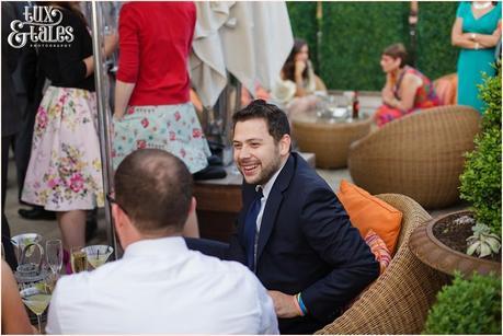 Guests chatting on terrace at Great John Street Hotel wedding