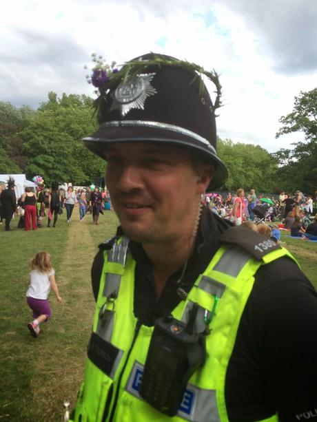A local policeman gets into the festival spirit with a flower crown.