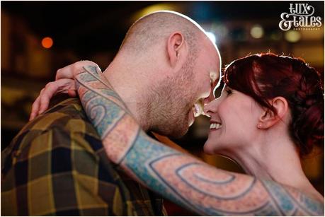 Engaged coupel kiss on stage at Hyde Park Pciture House Tattooed couple