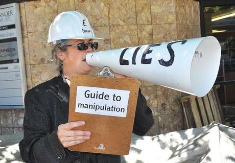 Statement: Rebecca Kneen takes part in an anti-pipeline demonstration held Monday in front of MLA Greg Kyllo’s office.— Image Credit: James Murray/Observer