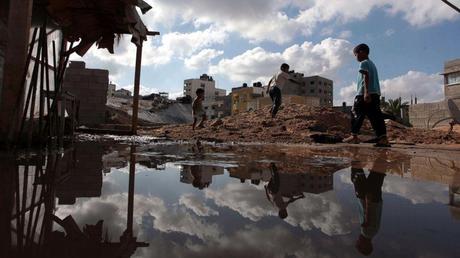 Palestinians inspect a house destroyed in air attacks staged by the Israeli army in Gaza City, Gaza, July 14, 2014. Ashraf Amra/Anadolu Agency/Getty Images