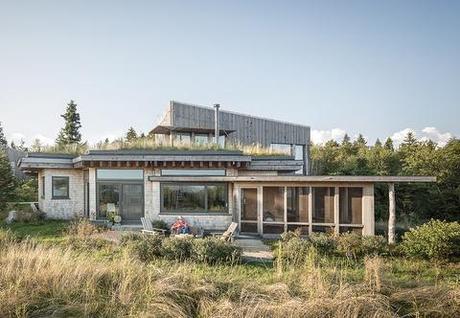 Wooden home with a green roof in Maine
