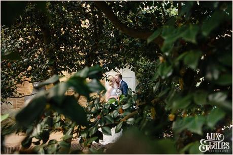 Bride and groom kiss in Orangery at Yorkshire Sculpture Park