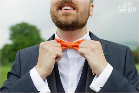 Groom adjusts bow tie at yorkshire sculpture park wedding