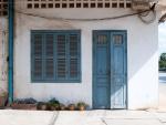 Blue door and window on one of the corner shops