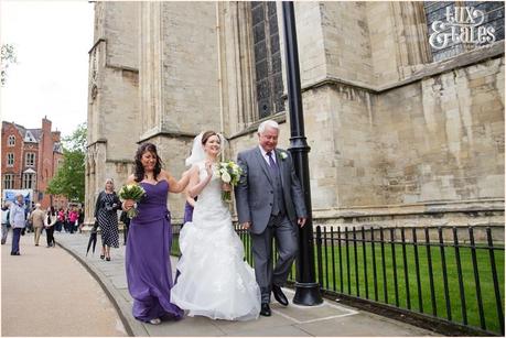 Bride walking up tot he minster for wedding