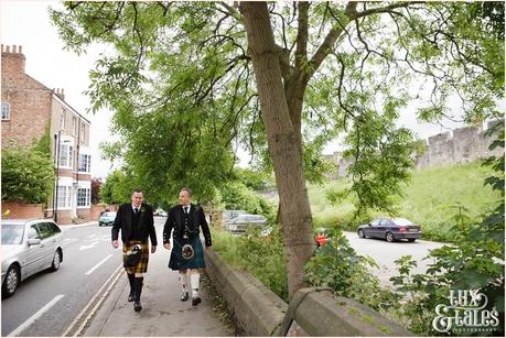 Groom and best man walking in york kilts