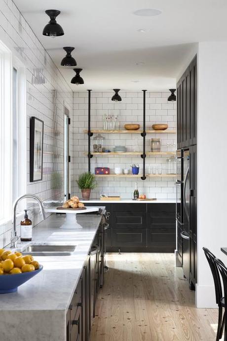 Modern kitchen with white subway tiles and black cabinets