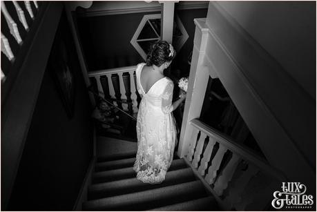 Bride walks down stairs Tux & Tales Photography