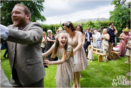 Bride and groom conga line up the aisle at Althrincham back garden wedding Tux & Tales Photography