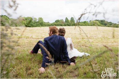 Bride and groom in an althrincham field. Tux & Tales Photography relaxed and natural photos 