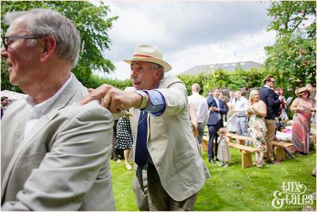 Bride and groom conga line up the aisle at Althrincham back garden wedding Tux & Tales Photography