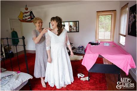 Bride preparation wedding photography getting into lace wedding dress