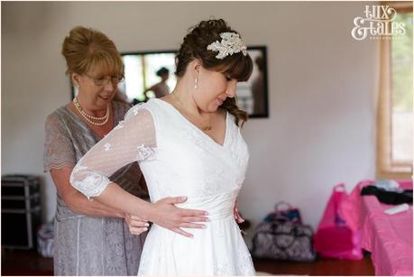 bride puts on lace wedding dress altrincham wedding