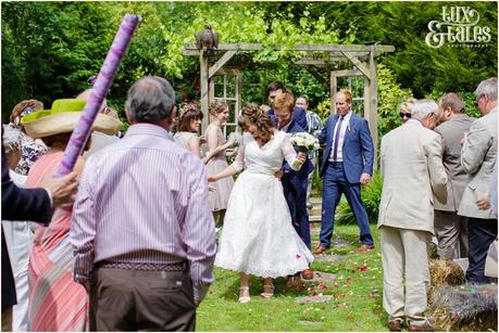 Bride and groom conga line up the aisle at Althrincham back garden wedding Tux & Tales Photography