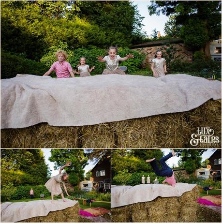 Kids playing on hay bales at Tipi wedding in back garden in Altrincham