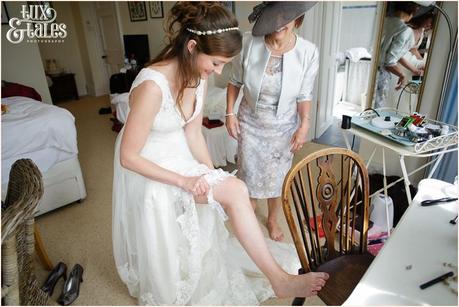 Bride puts on garter Woodlands B&B Wedding photography