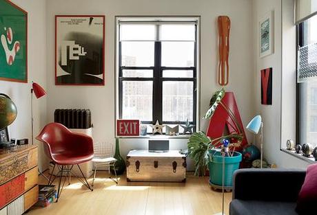 Bright modern living room renovation with red Eames chair and graphic prints
