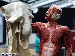 Human body holding up his own removed skin.