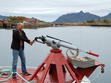 Leif Einar Karlsen, a whale hunter, shows how to harpoon whales in the port of Svolvaer in 2008