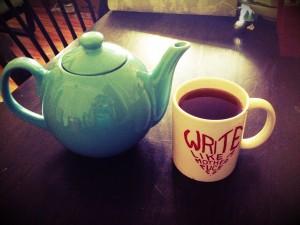 A teapot and a mug that says, 