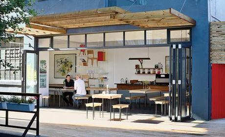 Field Office coffee shop exterior with wood overhang and tables