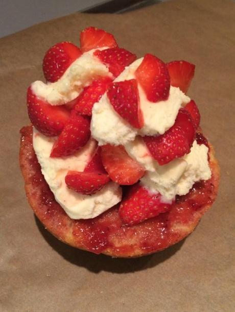 piling strawberries and cream for baked alaska recipe