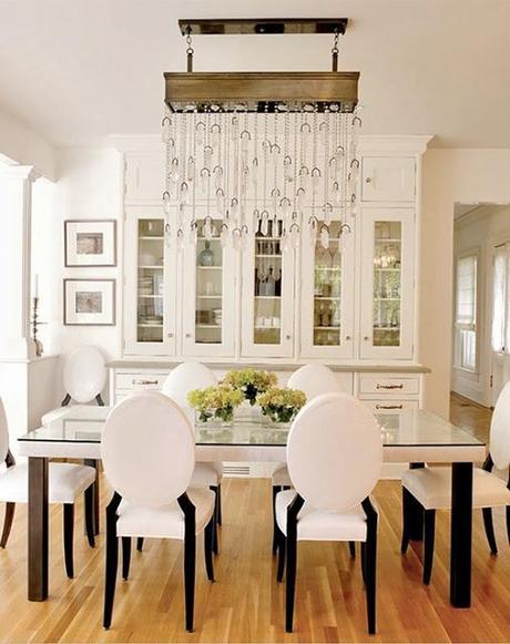 crystal drop chandelier in white dining room built in cabinets elegant style