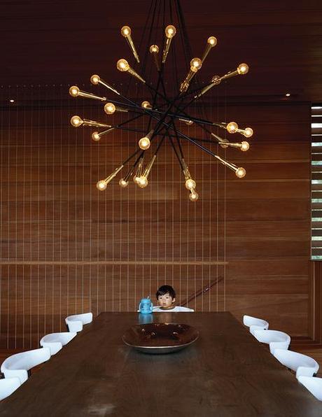 Dining room with Sputnik-style chandelier and oxidized maple table