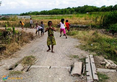 Children playing shy in Timur, running from the photographer