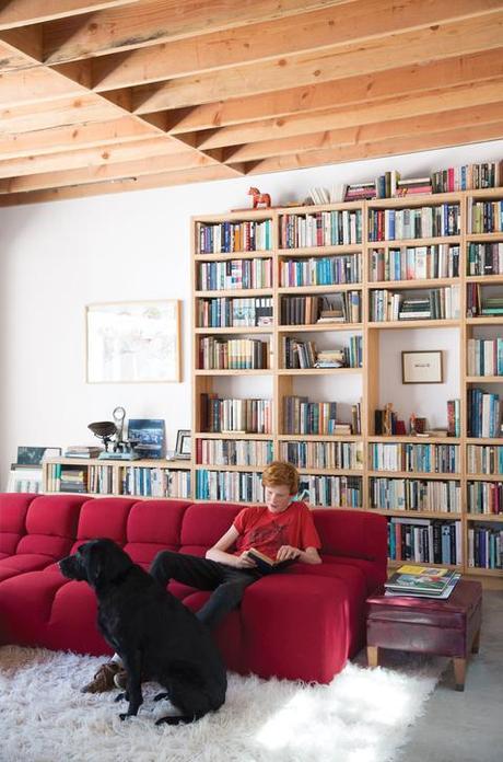 Family room with red B&B Italia sofa and furry white rug